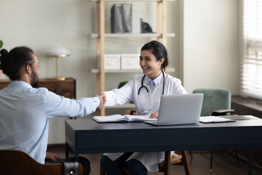 Medical professional shaking hand with patient