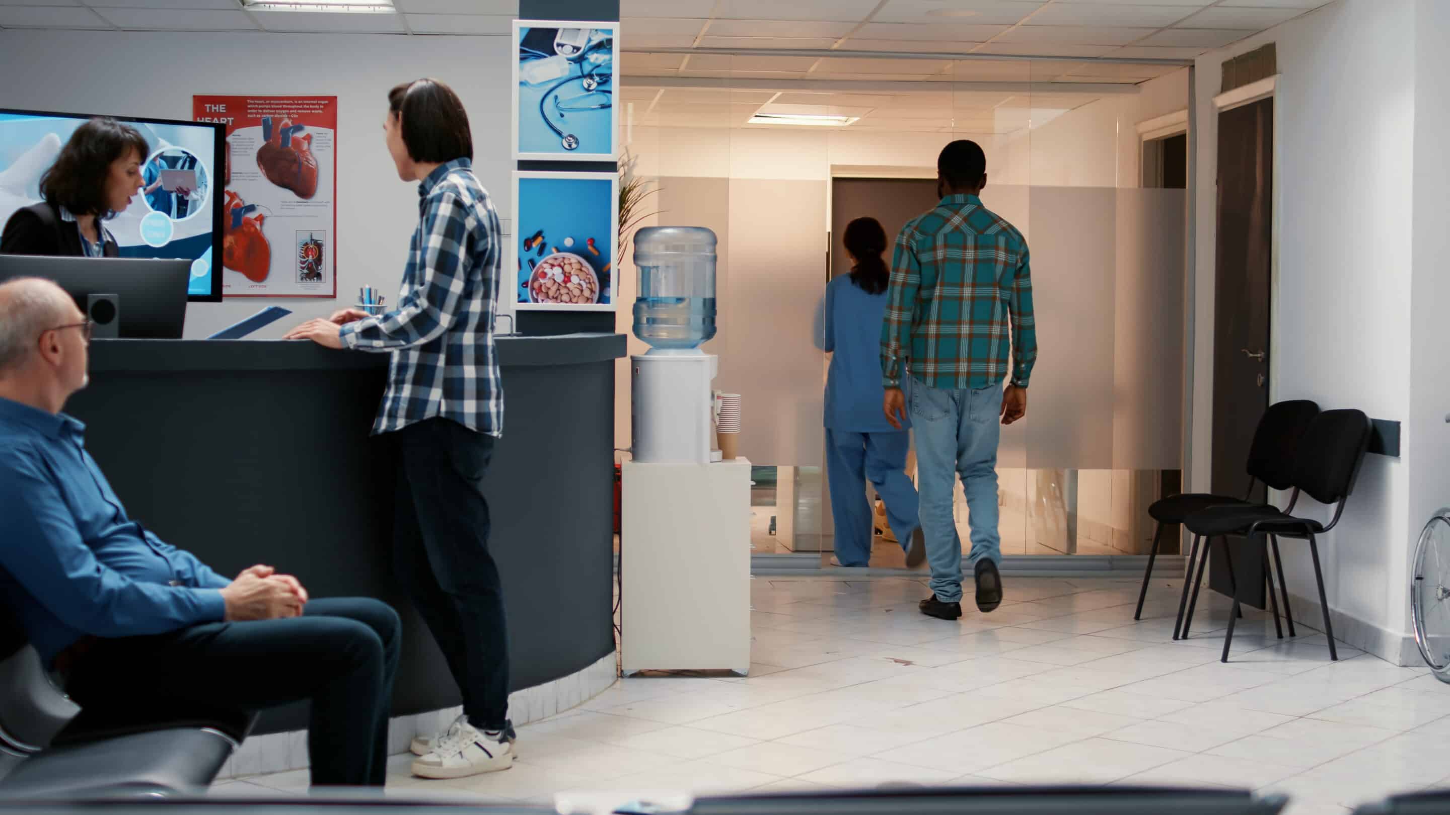 Medical Assistant Asking African American Man To Attend Consulta